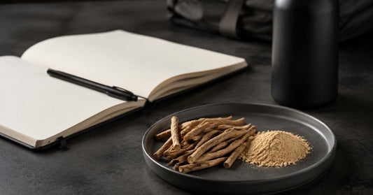 Ashwagandha roots and powder beside a blank research notebook.