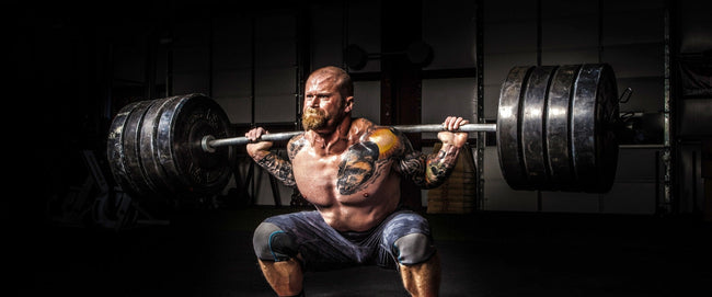 man doing heavy barbell squat
