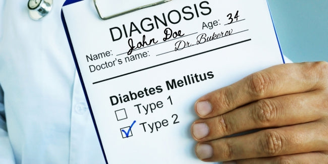 Doctor holding a diagnosis sheet reading "diabetes mellitus type 2"